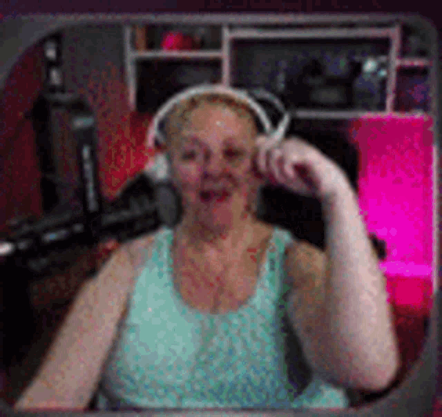 a woman wearing headphones is sitting in a chair in front of a computer .