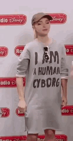 a woman wearing a t-shirt that says `` i am a human cyborg '' is dancing .
