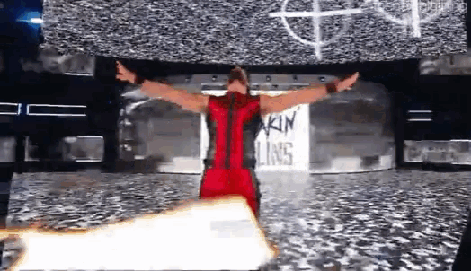 a man in a red and black outfit stands in front of a sign that says kin lines