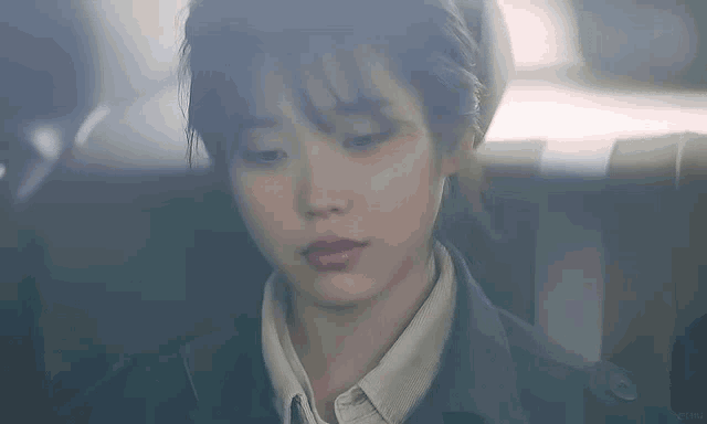 a close up of a woman 's face looking down