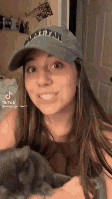 a woman wearing a hat with utah on it
