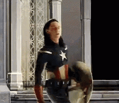 a woman dressed as captain america is holding a shield .
