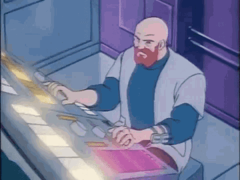 a bald man with a red beard is sitting at a desk in a room holding a sword .