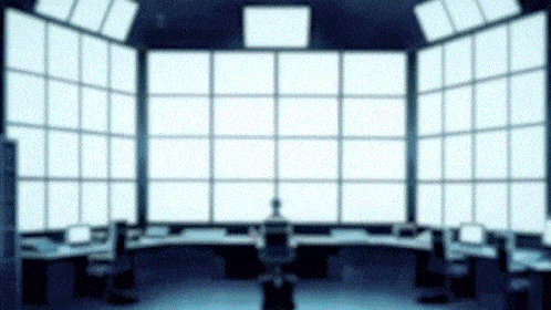 a blurred image of a control room with a lot of monitors