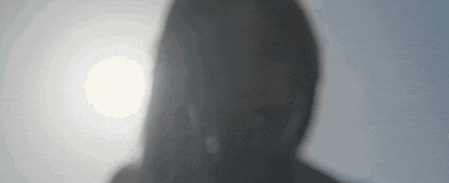 a close up of a person 's face with a light behind it
