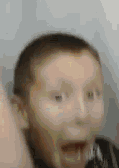 a close up of a person 's face with a blurred background .