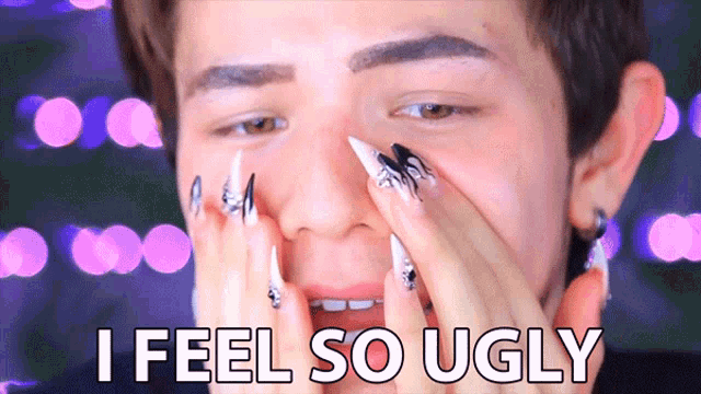 a man with long nails covering his face and the words i feel so ugly