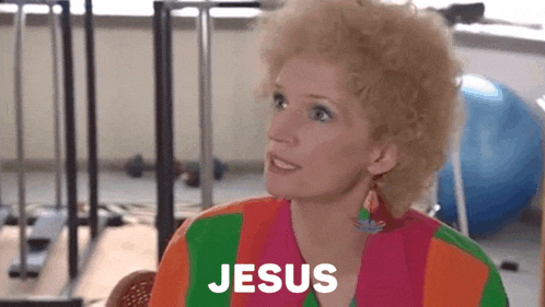 a woman in a colorful shirt says jesus in front of her