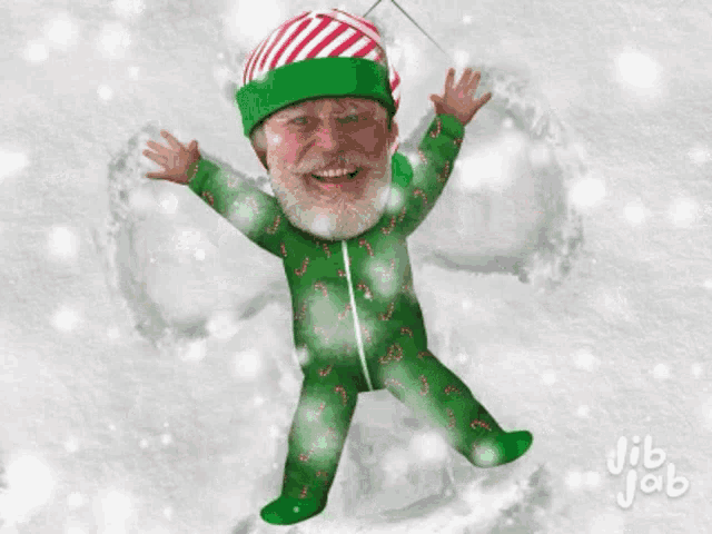 a man in a green pajamas with candy canes on them is standing in the snow