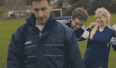 a girl in a blue adidas jersey is laughing with her team