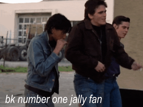 a group of men are walking in a parking lot with the words bk number one jolly fan written on the bottom