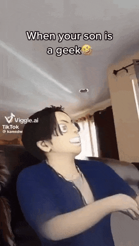 a man in a blue shirt is sitting on a couch in a living room and making a face .