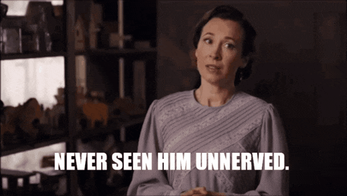 a woman says " never seen him unnerved " while standing in front of a shelf