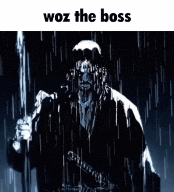 a man is holding a sword in the rain .