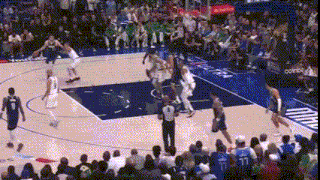 a basketball game is being played in front of a crowd with a sign that says comcast
