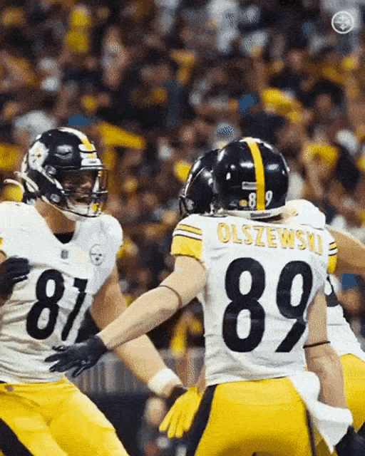 a football player with the number 89 on his back is hugging another player