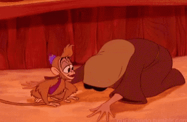 a cartoon character is kneeling down next to a small monkey