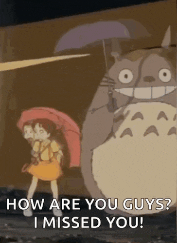 a girl holding an umbrella is standing next to a totoro .