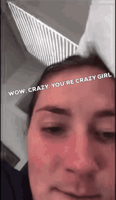 a woman wearing bunny ears has the words wow crazy you 're crazy girl written on her face