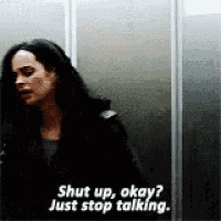 a woman is standing in an elevator and talking to someone .
