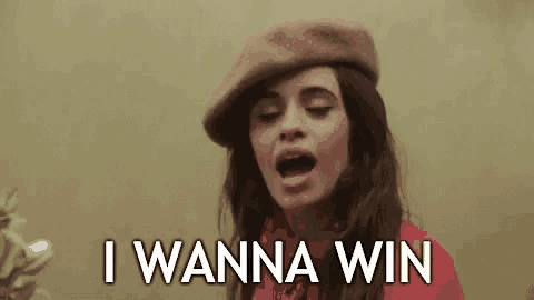 a close up of a woman wearing a hat and saying `` i wanna win '' .