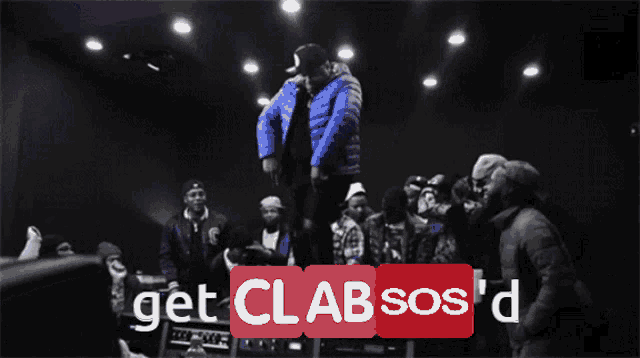 a man in a blue jacket is jumping in the air with the words get cl absos 'd below him