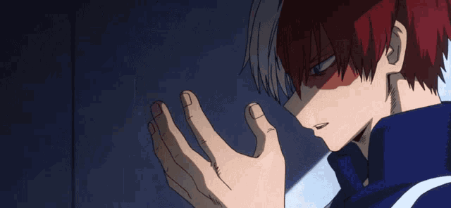 a person with red hair is covering their face with their hands
