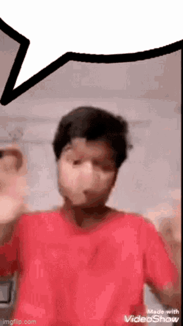 a man in a red shirt is making a funny face with a speech bubble above him .