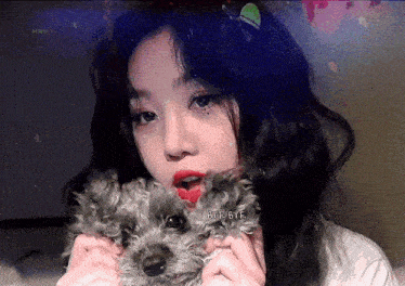 a girl is holding a small dog with the words bye bye written on it