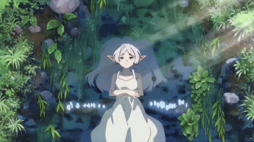 a girl in a white dress is laying on the ground
