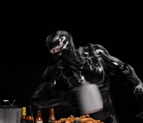 a man in a superhero costume is being splashed with liquid