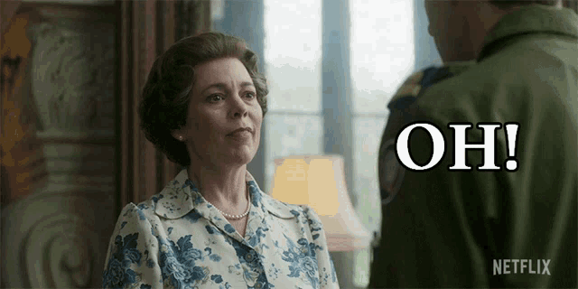 a woman in a blue and white floral shirt stands next to a man in a green uniform and the words oh are above her
