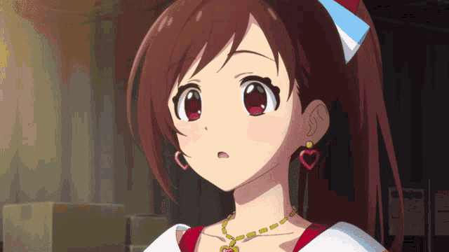 a close up of a girl wearing heart shaped earrings and a necklace