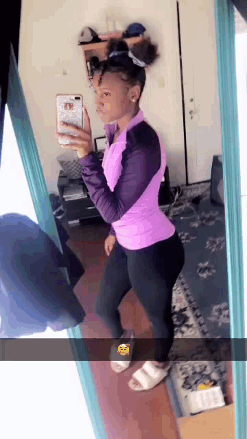 a woman is taking a picture of herself in front of a mirror