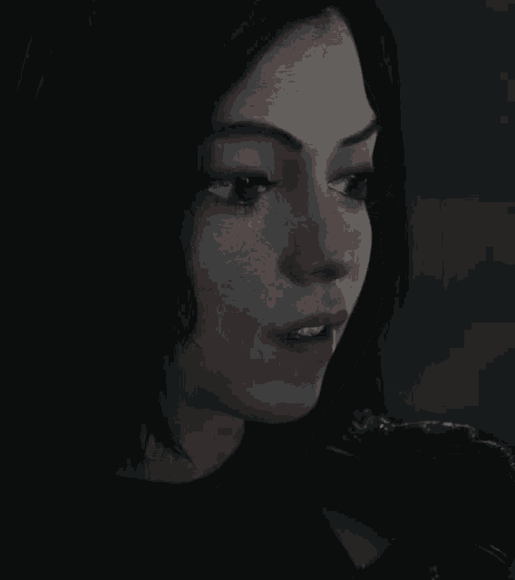 a close up of a woman 's face with a serious look on her face