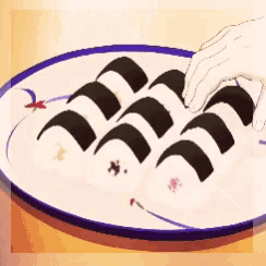 a person 's hand is reaching for a piece of sushi on a white plate
