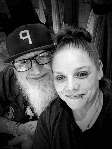 a man with a beard wears a hat with the letter 9 on it