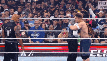 a wrestler with a blue shirt that says caliber on it
