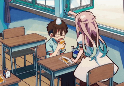 a boy and a girl are sitting at desks in a classroom and the boy is eating a sandwich