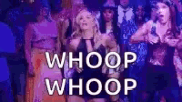 a woman is dancing in front of a group of people and the words `` whoop whoop '' are written in white letters .