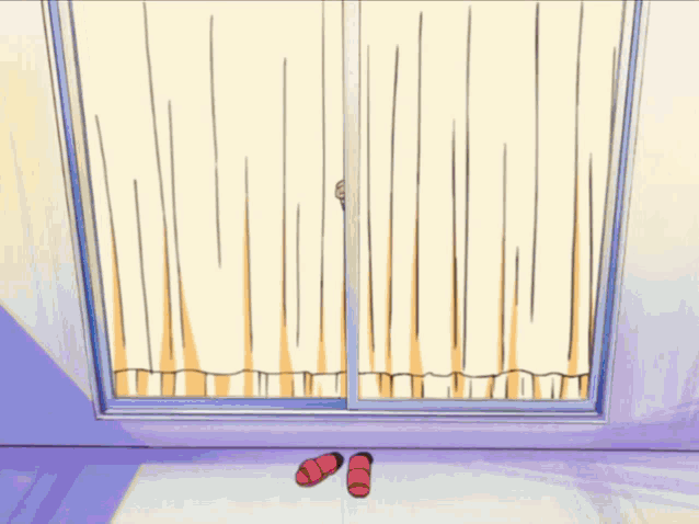 a person peeking out of a window with a pair of red slippers on the floor