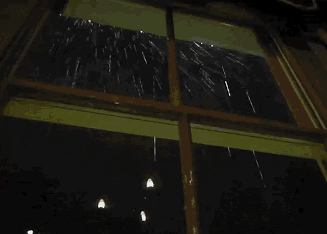 a window with a reflection of a street light on it