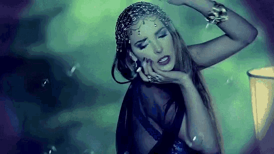 a woman in a black dress and headpiece is dancing
