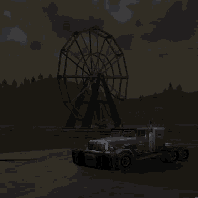 a truck is parked in front of a large ferris wheel in the dark