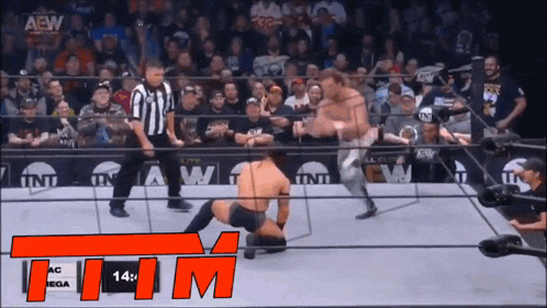a wrestling match is being shown on a screen that says aew