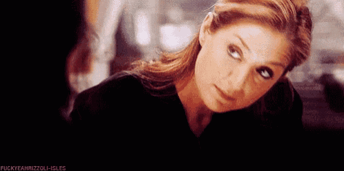 a close up of a woman 's face with a black shirt on .