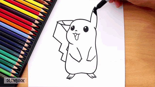 a person is drawing a pikachu on a piece of paper with colored pencils in the background