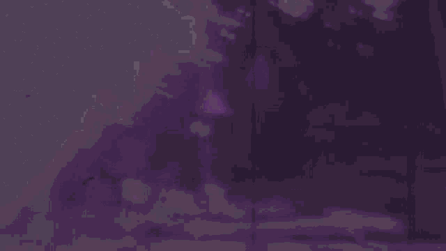 a blurry picture of a lake with a purple sky in the background