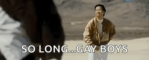 a man in a brown jacket is standing in the desert with the words `` so long ... gay boys '' written on the screen .
