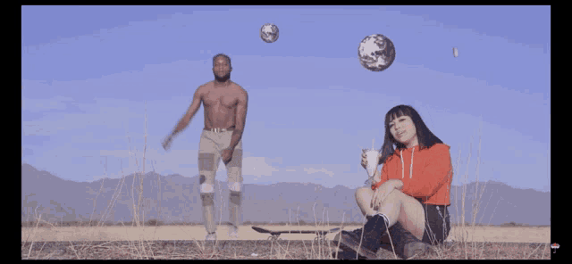 a man and a woman are in a field with a skateboard
